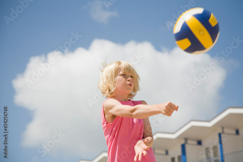 Blonde boy playing volleyball
 photo