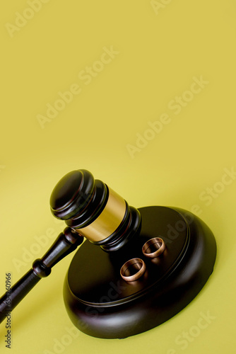 Judge gavel and two golden marriage ring, Contract decree of divorce dissolution or cancellation of marriage photo