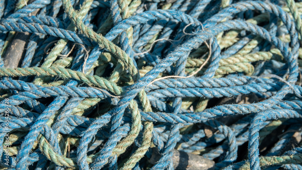 close up view of blue green maritime ropes  on the quayside