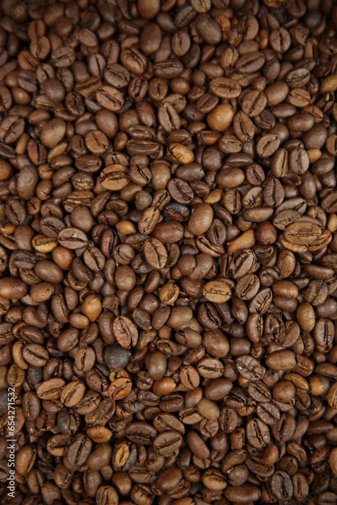 Coffee beans. Coffee beans are spread out on the surface.