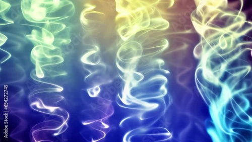 Wispy and thin billowing smoke on a blue and yellow background. Depth of field.
