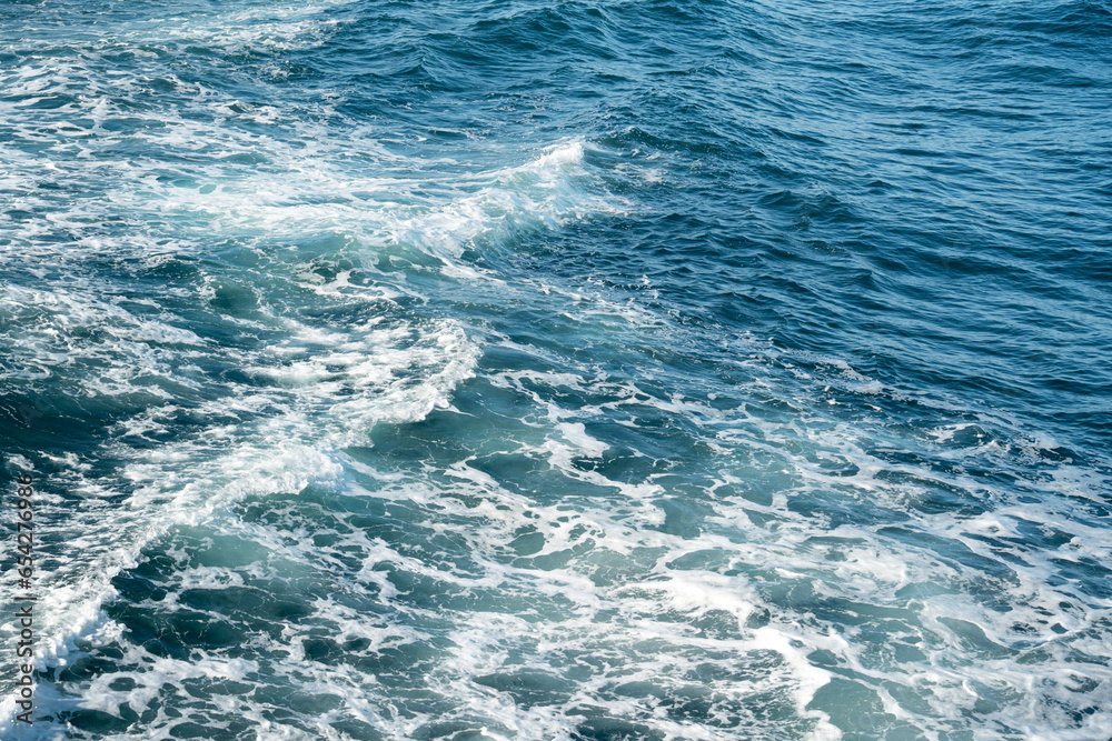 Stormy sea ocean, water surface with white foam and waves.