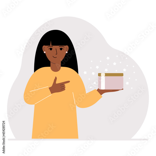 A woman holds a jar of cream in his palm.