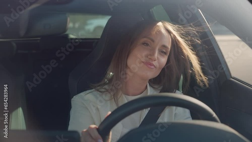 Contented lady expressing satisfaction while driving car