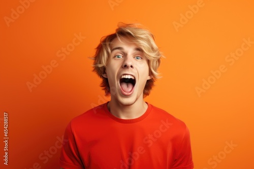A picture of a man with his mouth open and his tongue wide open. This image can be used to depict surprise, shock, or amazement. It can also be used to represent speech, expression, or communication. © Fotograf
