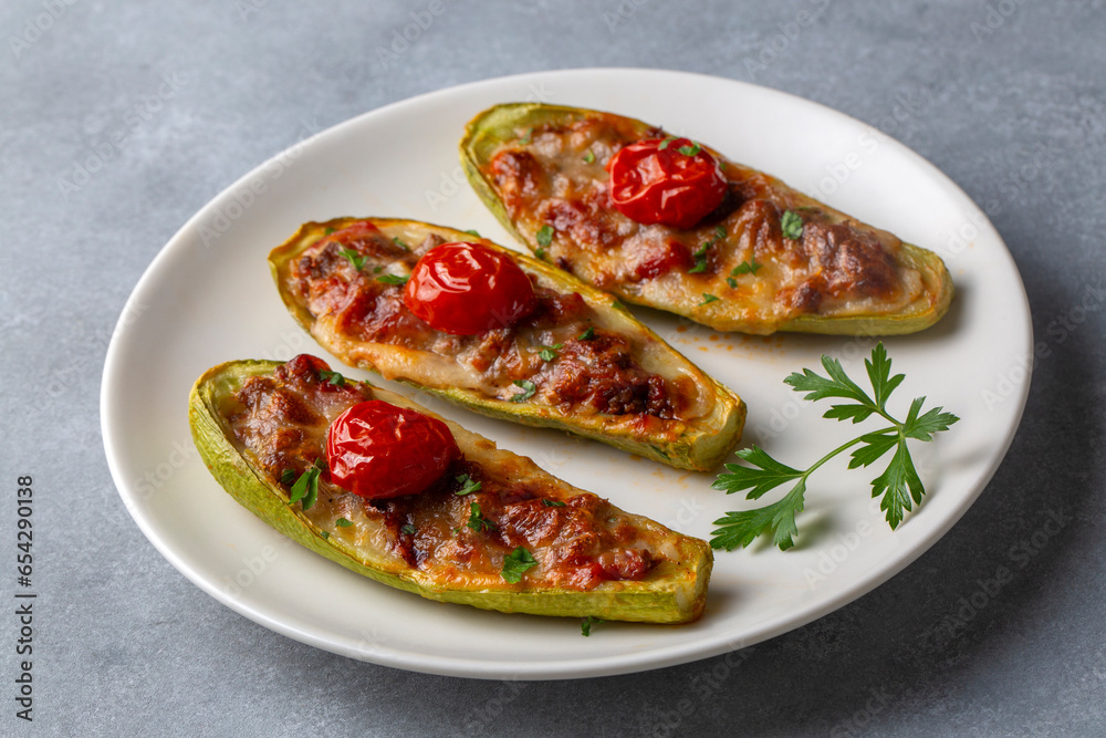 Zucchini stuffed with meat, vegetables and cheese. Zucchini boats. Turkish name; kabak sandal Zucchini stuffed with meat, vegetables and cheese. Zucchini boats. Turkish name; kabak sandal