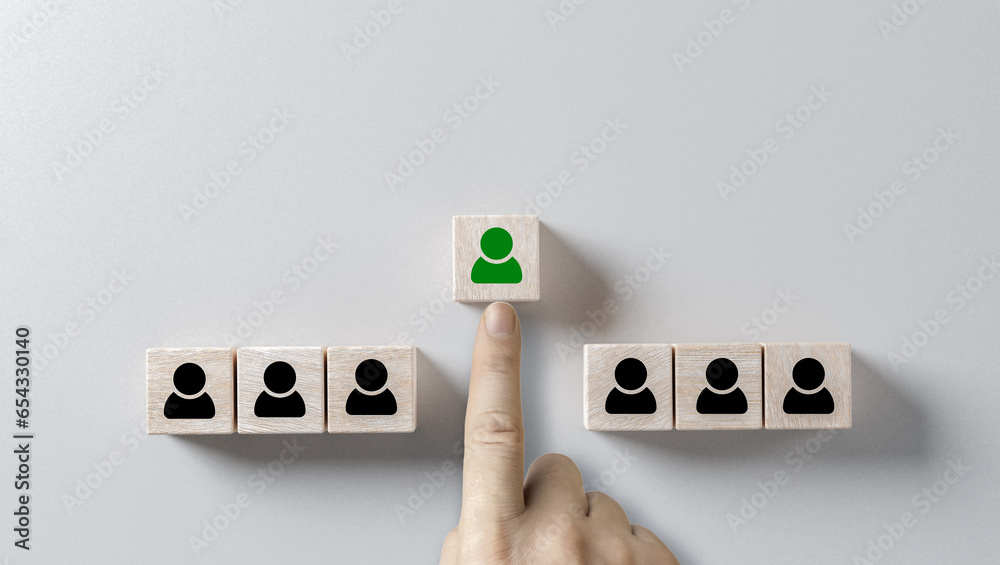 choosing right person. hand selects cube with person highlighted in green. Human resources management and recruitment business hiring concept, corporate hierarchy, recruiter chooses one leader person - obrazy, fototapety, plakaty 