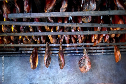 Traditional Montenegrin pork ham prshut is prepared in a smoke house photo