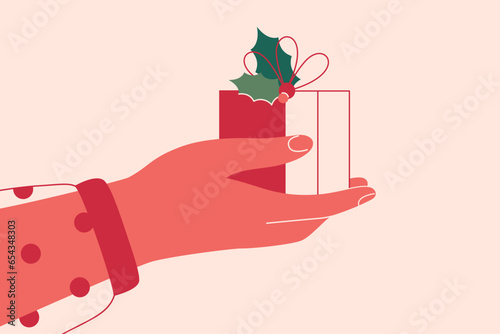 Christmas red gift box decorated with holly leaves in the human hand. Female arm holds xmas surprise in holiday wrapping. Friend or colleague shares present for winter events. Vector illustration