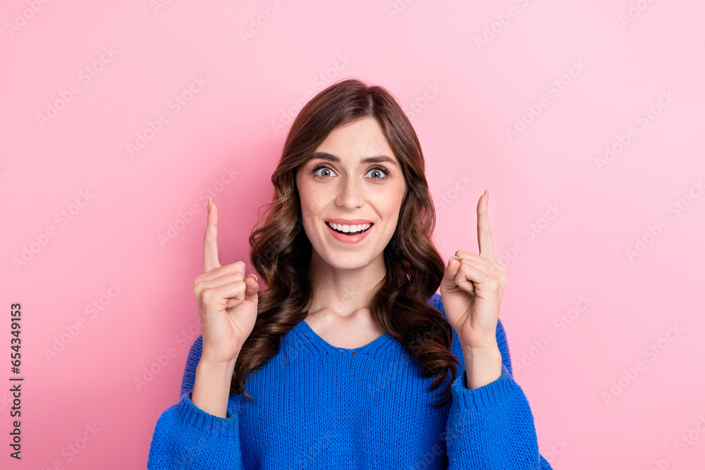 Photo of astonised cheerful girl wear stylish blue clothes two arm direct special proposition empty space isolated on pink color background Photo of astonised cheerful girl wear stylish blue clothes two arm direct special proposition empty space isolated on pink color background