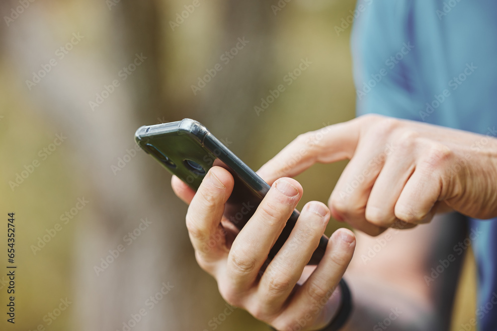 Hands, closeup and phone or outdoor exercise for fitness or location for training or communication. Runner, typing and health progress on workout app or touch screen for directions, wellness or sport Hands, closeup and phone or outdoor exercise for fitness or location for training or communication. Runner, typing and health progress on workout app or touch screen for directions, wellness or sport