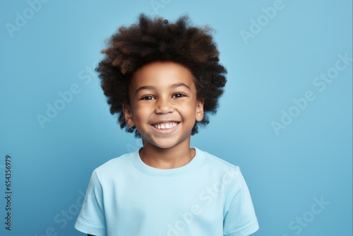 Happy African American Boy Portrait on Blue Background. Smiling Face of a Young Black Child