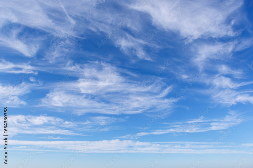 Beautiful blue sky over the sea with translucent, white, Cirrus clouds