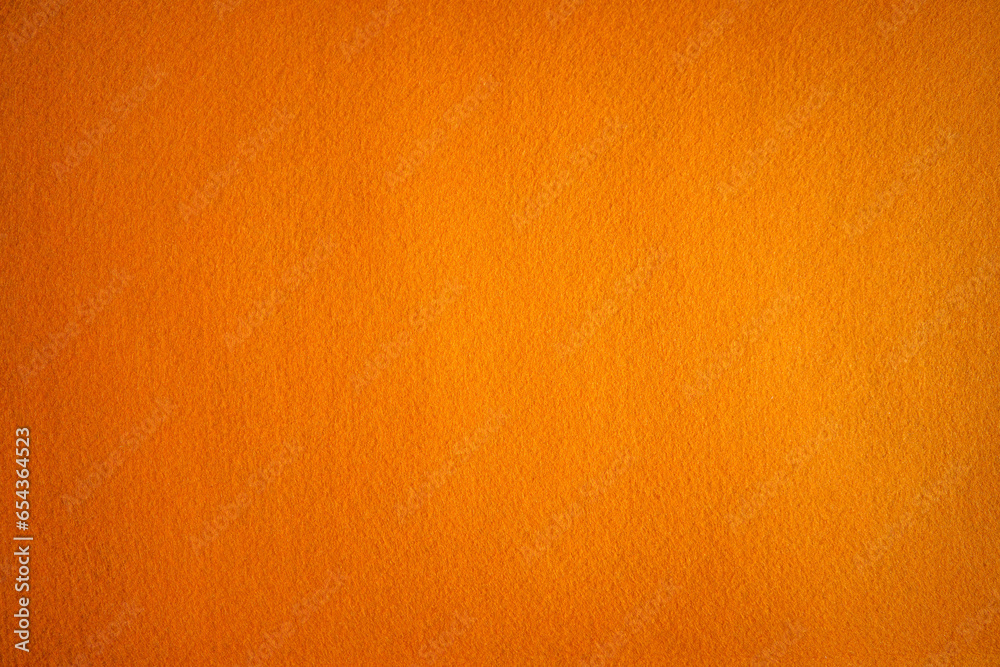 Photo of an orange background texture made of felt fabric. Soft textiles of red color. Photo of an orange background texture made of felt fabric. Soft textiles of red color.