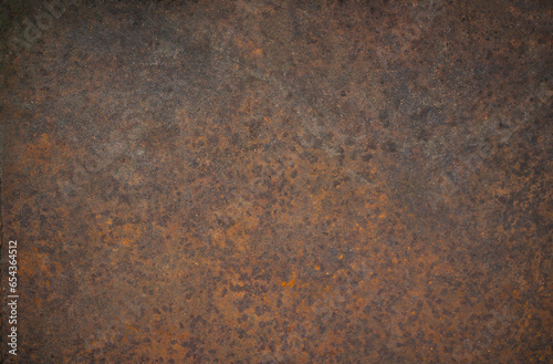 Photo of the texture of a metal rusty wall. Rusty iron background. The spread of corrosion on the surface.