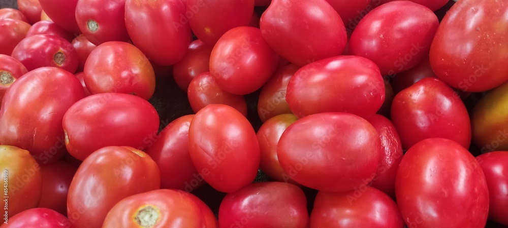 Tomatoes lying on a pile on top of each other, tomato texture. Selective focus. Tomatoes lying on a pile on top of each other, tomato texture. Selective focus.