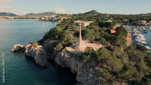 Aerial shot, drone point of view touristic resort, popular travel destination Santa Ponsa town in Baleares, Majorca Island in Spain. Mediterranean Sea view, townscape and religious monument in port photo