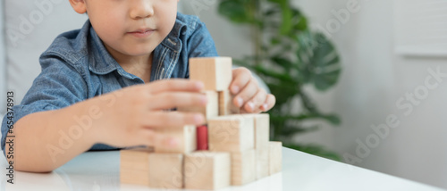Tablou pe pânză Happy Asian child playing and learning toy blocks