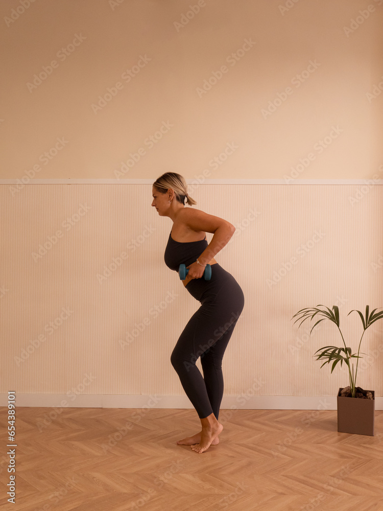 Woman training with a dumbell Woman training with a dumbell