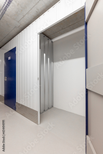 Corridor of self storage unit with blue doors. Rental Storage Units