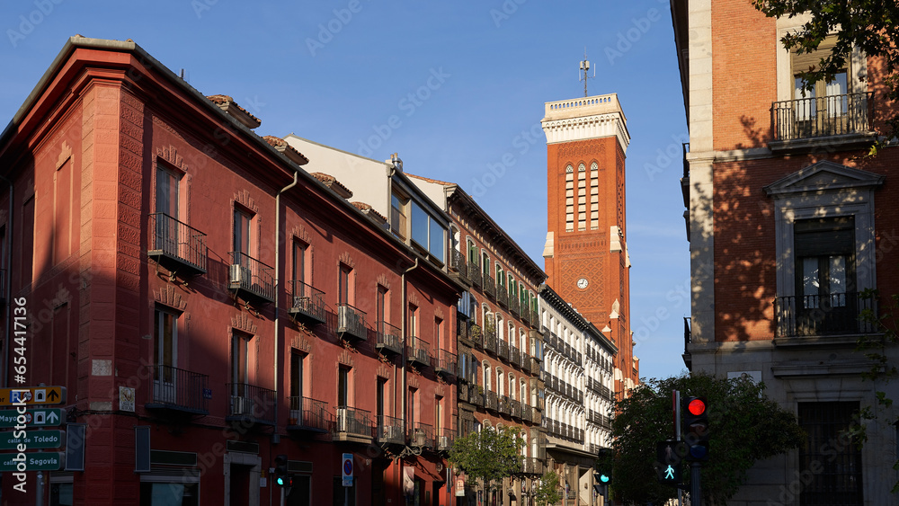 Madrid, Spain. Beautiful Calle de Atocha street with bell tower of thee Church of Santa Cruz