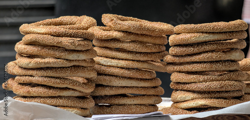 Fototapeta Naklejka Na Ścianę i Meble -  greek sesame bagels (Koulouri) for sale stacked in a pile on the street in Greece (athens street food, breakfast, bread with sesame seeds)