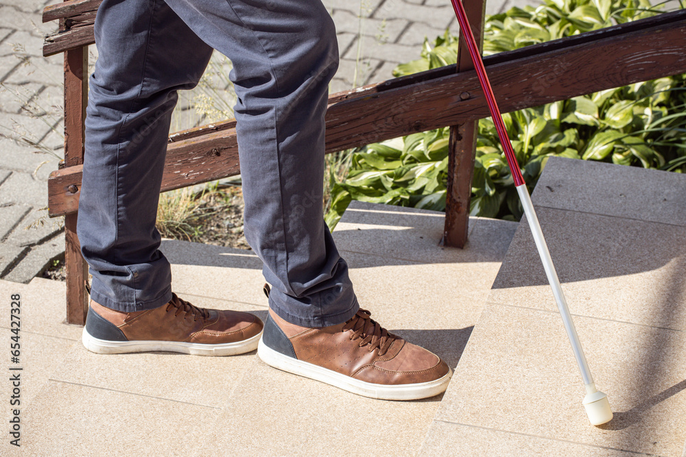A blind man tries to climb the stairs, Problems of blind people, Concept, Barriers and social exclusion of people with disabilities A blind man tries to climb the stairs, Problems of blind people, Concept, Barriers and social exclusion of people with disabilities