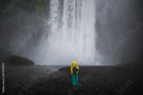 Skogafoss Waterfall with a model in front of the falls in Iceland photo