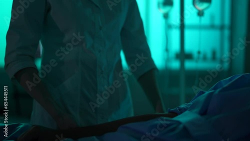 Close-up detail video of an unrecognisable woman, nurse, female doctor desinfecting an arm of a patient laying in a hospital bed, giving him an injection. photo