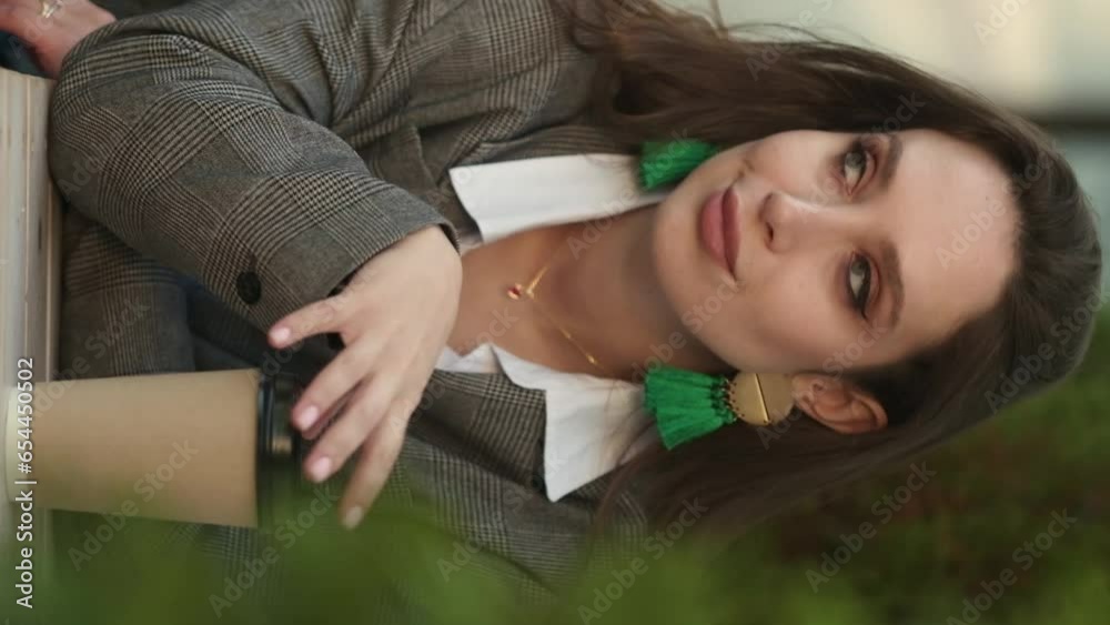 Attractive woman holding cup, enjoy tea, drink morning invigorating coffee beverage while sit at cafe before start work. Break, pause, daydreaming concept. Vertical video 