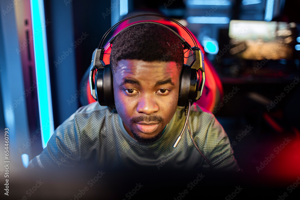 Professional gamer wearing headphones participating in eSport tournament