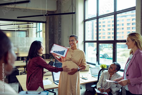 Diverse group of colleagues working on a project together in a modern office