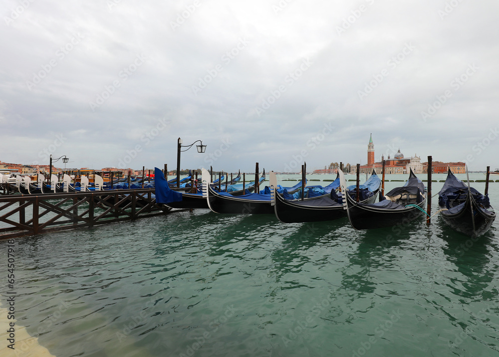 gondolas moored in the Venetian lagoon Venice during high tide