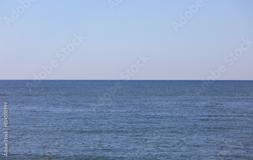 very simple neutral background with the sea under the blue sky above without boats without people