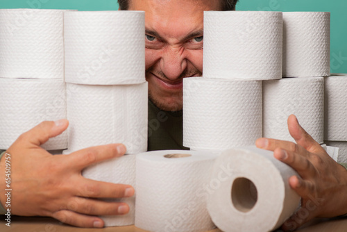 A greedy man hides in toilet paper supplies.