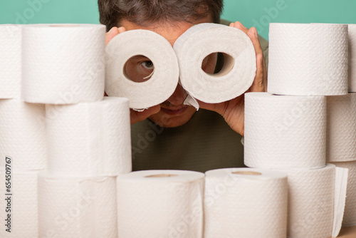Binoculars made of toilet paper in the hands of a thrifty and greedy hamster.