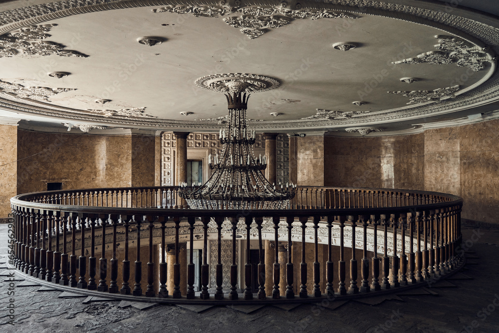 Abandoned soviet spa resort (sanatorium) Metallurg, in Tskaltubo, Georgia. Mezzanine floor, huge crystal luster in the centre. Celling with  rosettes. Stalin empire style   - obrazy, fototapety, plakaty 