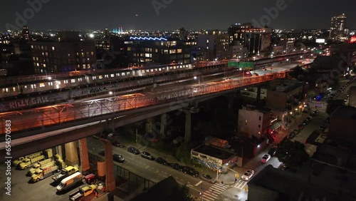 Aerial view of a subway train passing through Brooklyn, New York City at night