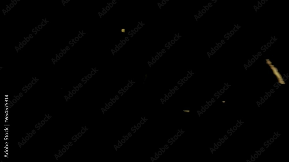 Bottom view isolated slow motion macro shooting capturing lots of ribbed potato chips falling down to the camera from above. Black background.