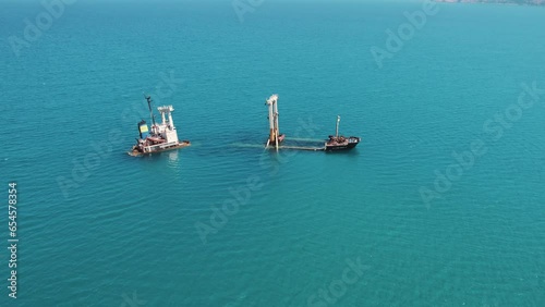 Sea transportation incidents. Aerial view of Manassa Rose Shipwreck in Kissamos bay. Turquoise seawater surrounding the shipwreck. High quality 4k footage photo