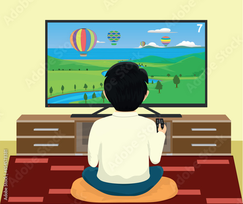 boy changing channels while watching television