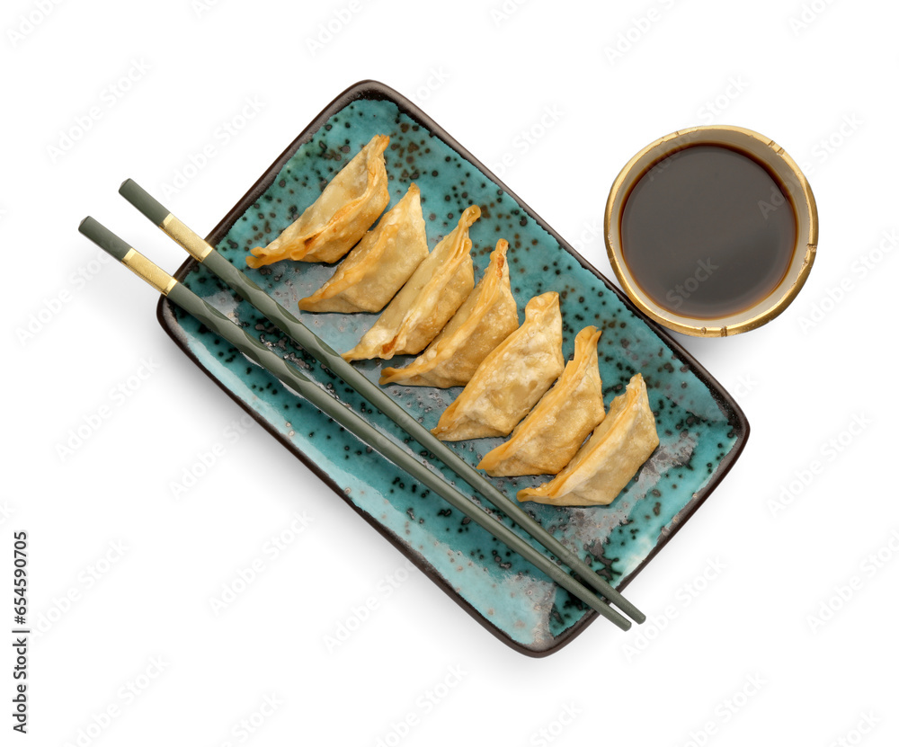 Delicious gyoza (asian dumplings), soy sauce and chopsticks isolated on white, top view Delicious gyoza (asian dumplings), soy sauce and chopsticks isolated on white, top view