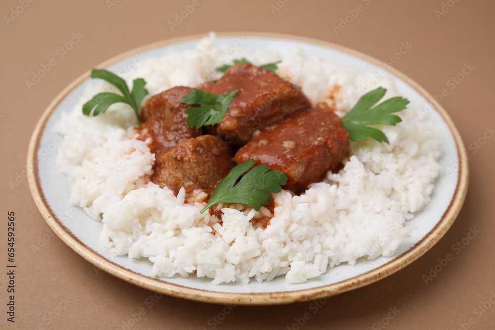 Delicious goulash with rice on brown background, closeup Delicious goulash with rice on brown background, closeup