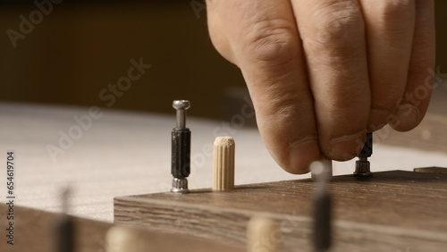 Repair concept. Creative. A man in uniform collecting stores and doing painting in a closed room. © Media Whale Stock