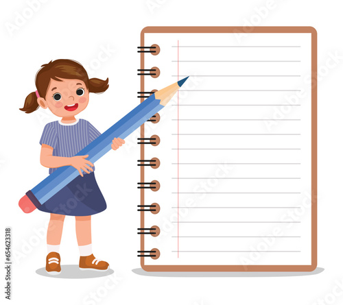 Cute little girl student holding big pencil standing with big notebook