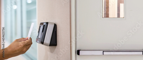 Proximity card door unlock, Hand security man using fingerprint scan on ID card reader access control system for identity verification to open the door or for security safety or check attendance. photo