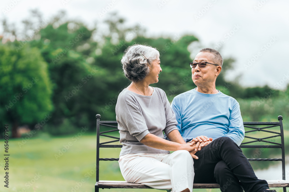 Asian people mature husband and wife, seated on chairs, elderly couple, seated in the park on comfortable chair, deep love and lifelong. Elderly Love Senior Couples, long life togetherness Asian people mature husband and wife, seated on chairs, elderly couple, seated in the park on comfortable chair, deep love and lifelong. Elderly Love Senior Couples, long life togetherness