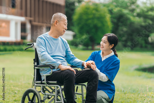 Asian people elderly man on wheelchair with caregiver nurse outdoor, , exemplifying the essence of holistic well-being and compassionate support. Nature Therapy