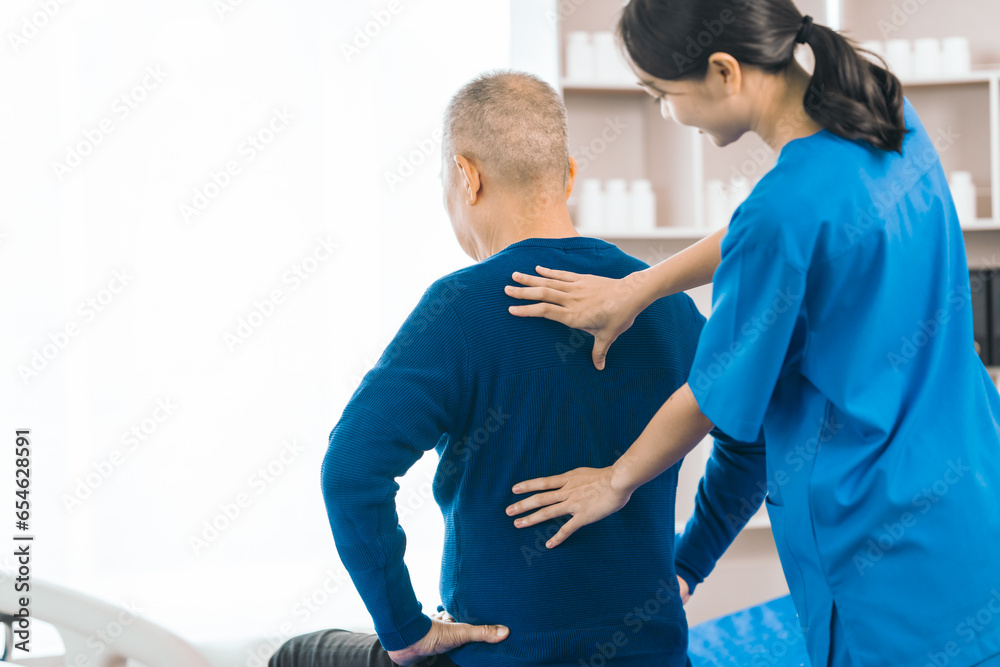 Obraz premium Asian people caregiver provides gentle support and encouragement to an elderly man during physical therapy session in a nursing care facility, promoting strength, mobility, and well-being.