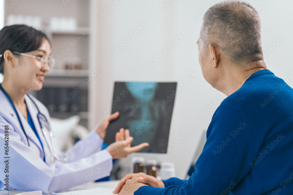 Obraz premium Asian people experienced female doctor giving advice to elderly male patient cancer and x-ray results and treatment options, Cancer Consultation, Elderly Man Receives Expert Cancer Advice Awareness